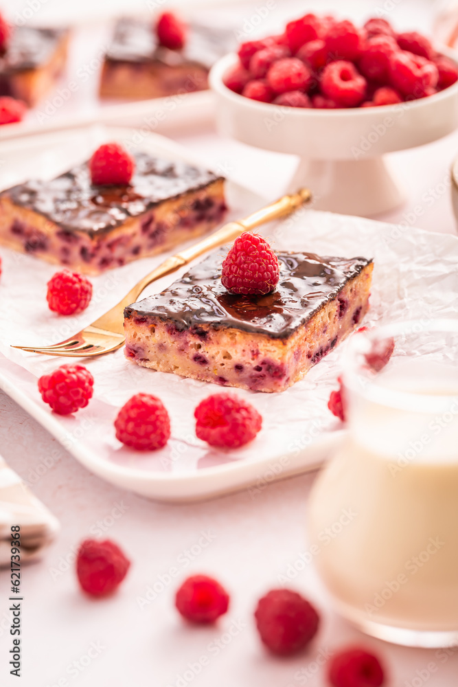 Traditional buttermilk sheet cake with raspberries and  chocolate ganache