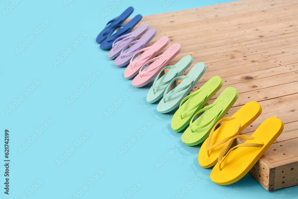 Many different flip-flops on blue background Many different flip-flops on blue background