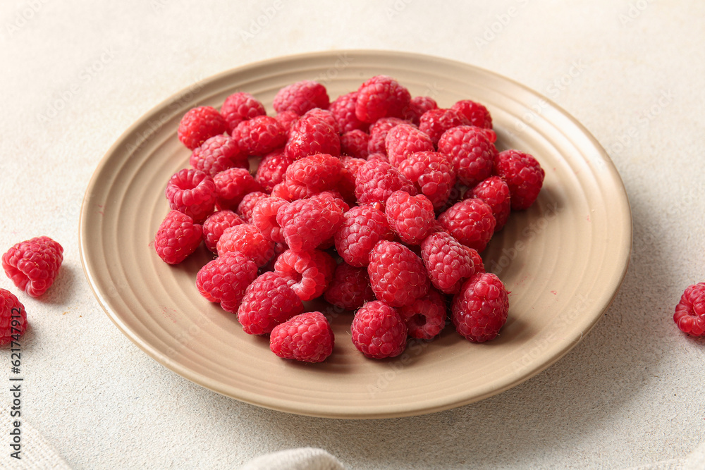 Plate with fresh raspberries on white background Plate with fresh raspberries on white background