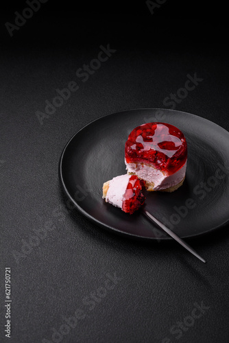 Delicious fresh sweet cheesecake cake with berries and red color jelly