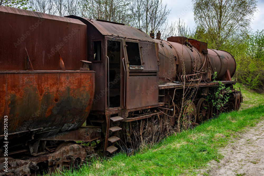 Naklejka premium Old rusted steam locomotive abandoned at train cemetery