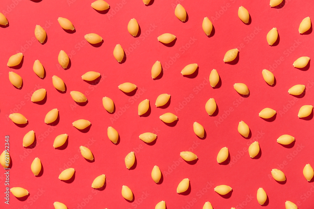 Uncooked pasta on red background Uncooked pasta on red background