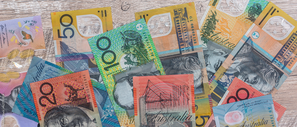 Australian dollars on wooden table as background