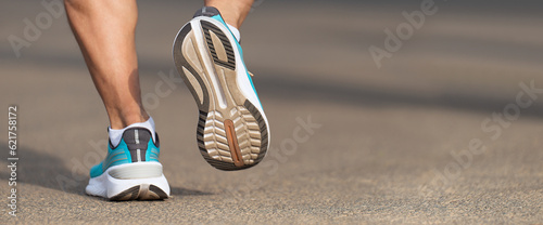 Running shoe close up of man running on road with sports shoes