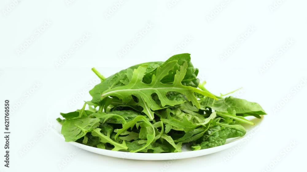 Vegetarianism. healthy eating. Lettuce leaves in a bowl isolated on white background. Mix fresh arugula leaves, lettuce leaves and spinach leaves for salad. Vegetarianism. healthy eating. Lettuce leaves in a bowl isolated on white background. Mix fresh arugula leaves, lettuce leaves and spinach leaves for salad.