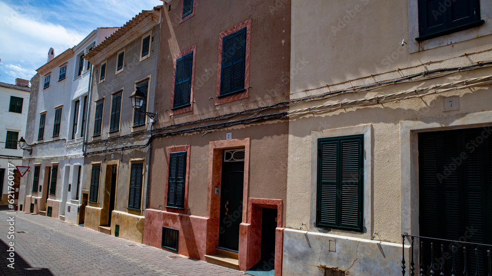 Naklejka premium Alaior, Menorca , cultural center of the island. street view and architecture. white houses an church