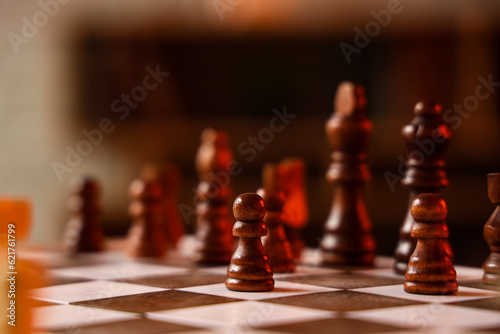 Chess pieces on game board in room  closeup