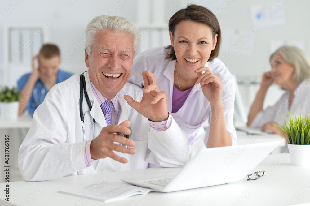 Male doctor sitting at table in clinic Male doctor sitting at table in clinic
