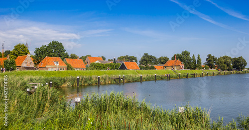 Panorama of little historic houses behind the dike in Enkhuizen, Netherlands photo