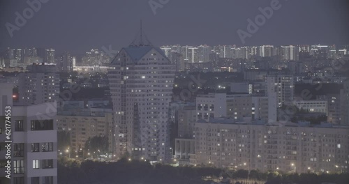 Modern Multi-storey Residential House. Elevated View Cityscape Skyline. Night Light Lighting Timelapse. Backdrop Night Time Lapse. Urban Cityscape At Evening Time. Ungraded, Canon, C-log, C Log, Log. photo
