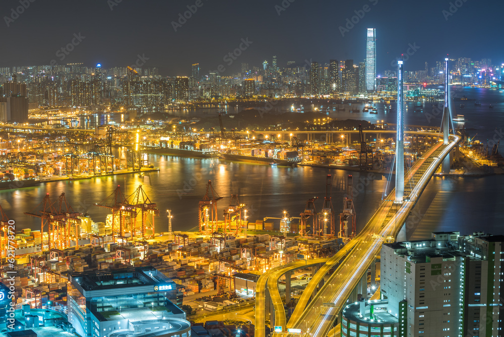 Aerial Night view of the city in Hong Kong with stonecutter bridge