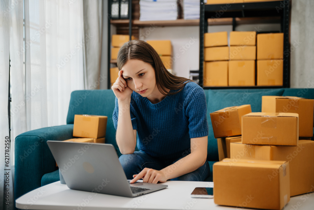 Caucasian young woman SME working using smartphone or tablet taking receive and checking online purchase shopping order to freelance online concept. Caucasian young woman SME working using smartphone or tablet taking receive and checking online purchase shopping order to freelance online concept.
