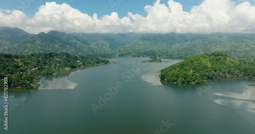 Mountain with rainforest sorrounded in Lake Sebu. Blue sky and clouds, drone view. Mindanao, Philippines. photo