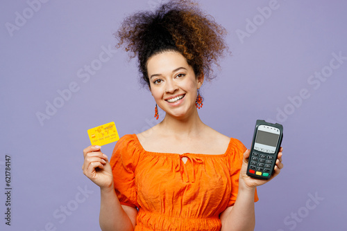 Fototapeta Young latin woman wear orange blouse casual clothes hold wireless modern bank pa