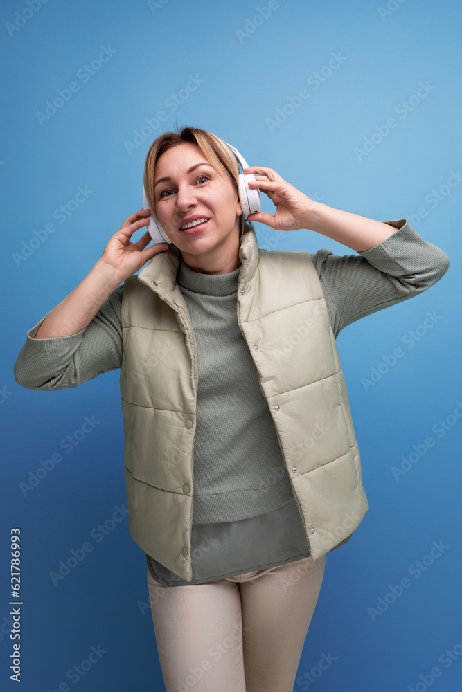 portrait of cute blond millennial woman with headphones portrait of cute blond millennial woman with headphones