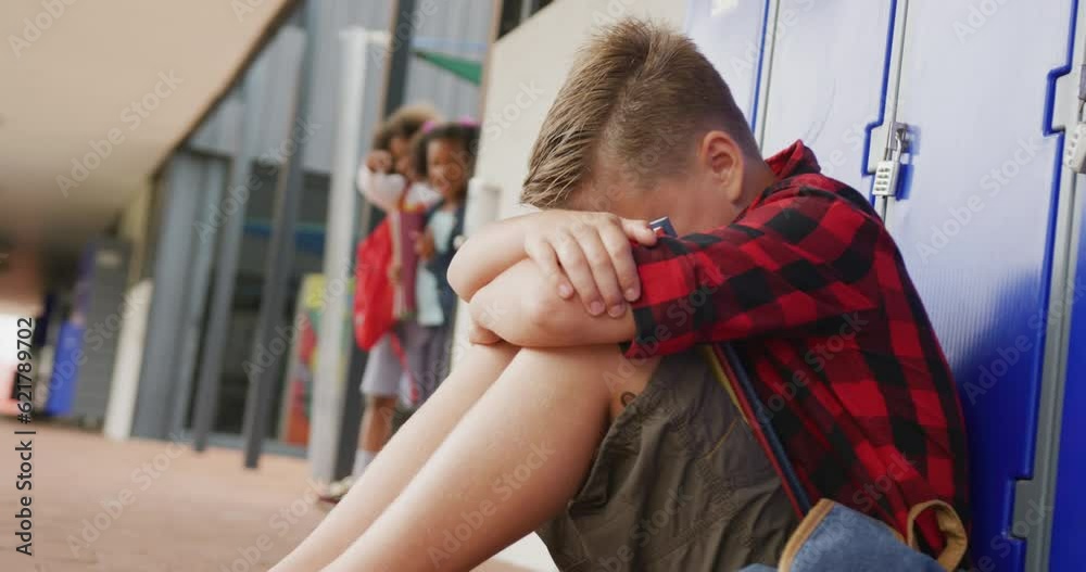 Video of sad caucasian schoolboy being taunted by two diverse children at school Video of sad caucasian schoolboy being taunted by two diverse children at school