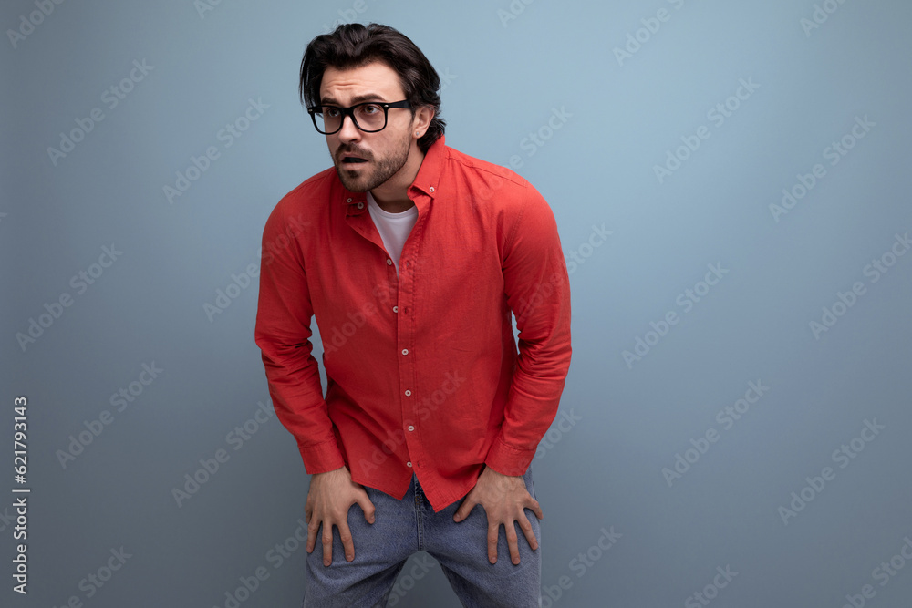 Obraz premium cute caucasian brunette 30s man in red shirt tired