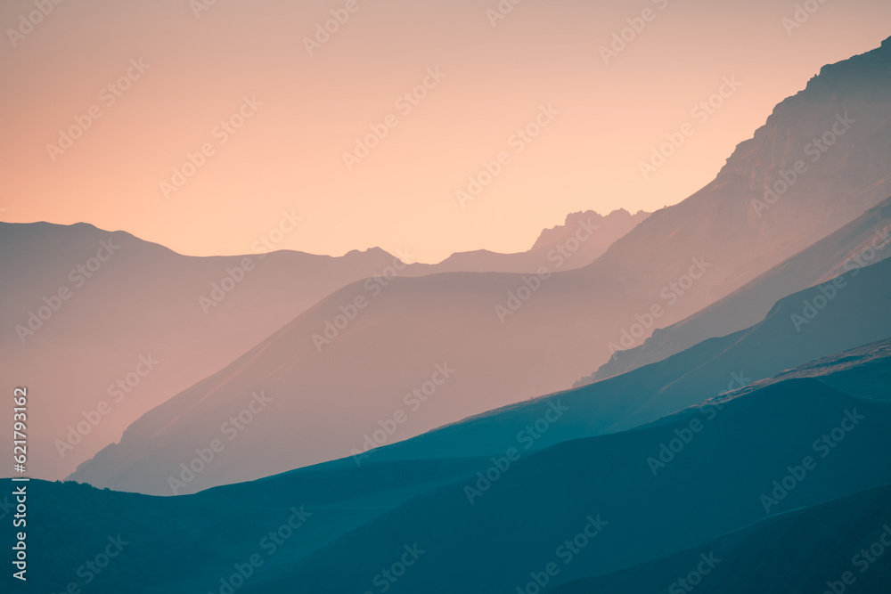 Mountains in the pink sunlight at sunset.