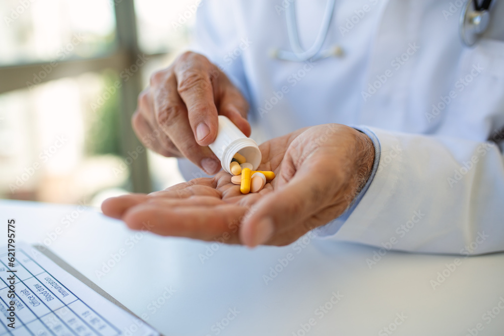 Hand of doctors holding many different pills. Photo of doctor prescribes pills and antibiotics. Medicine and treatment concept background. Hand of doctors holding many different pills. Photo of doctor prescribes pills and antibiotics. Medicine and treatment concept background.