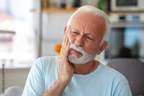 Tooth Pain And Dentistry. Senior Man Suffering From Terrible Strong Teeth Pain, Touching Cheek With Hand. Feeling Painful Toothache. Dental Care And Health Concept.