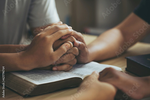 Slika na platnu Christian group of people Holding hands together and praying on the holy bible