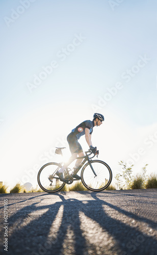 Mountain, sports and male cyclist cycling on bicycle training for a race or marathon in nature. Fitness, workout and man athlete riding a bike for cardio exercise on an outdoor off road trail. © Wesley JvR/peopleimages.com