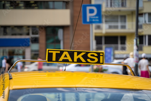 Yellow taxi sign on the street in Turkey.