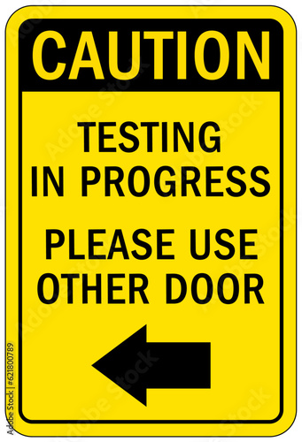 Testing in progress warning sign and labels please use other door