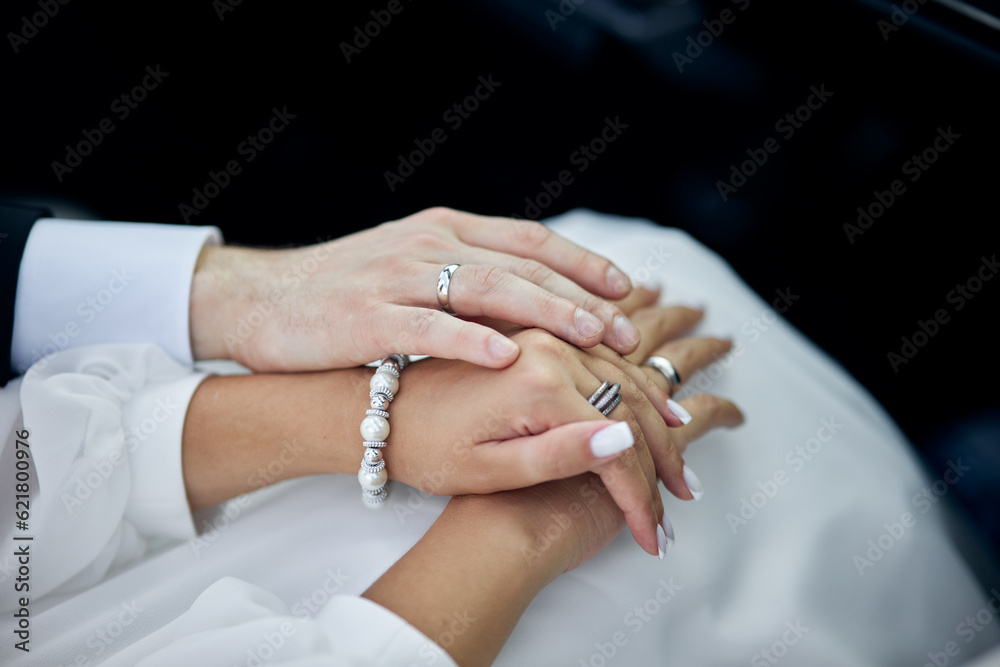 Fototapeta premium wedding rings on hands of the groom