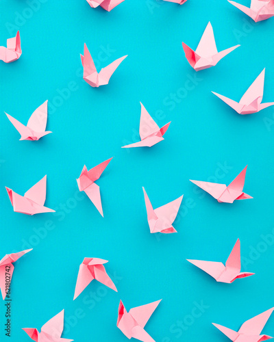 Generated photorealistic layout of origami paper pink cranes