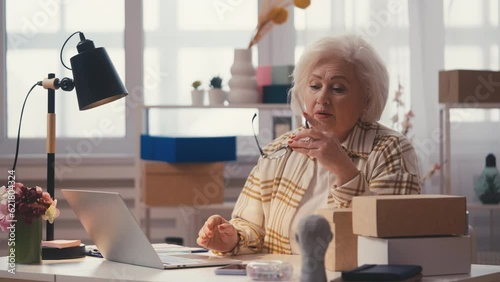 Senior woman entrepreneur displeased with failed order, reading bad news email