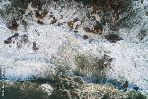 aerial overhead view of the waves on a rocky shore