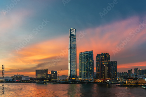 skyscraper, skyline and harbor of Hong Kong city under sunset