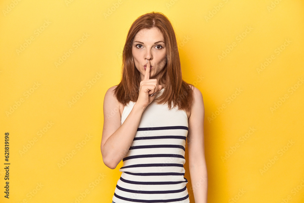 Redhead in a tank top, casual studio shot keeping a secret or asking for silence. Redhead in a tank top, casual studio shot keeping a secret or asking for silence.