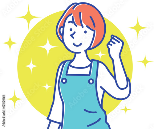 エプロン姿でガッツポーズする若い保育士の女性