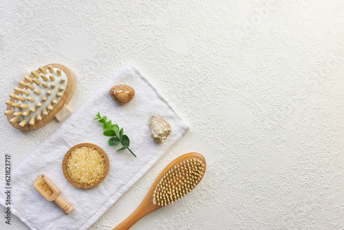 Cosmetic, massage and bath accessories set on white texture background