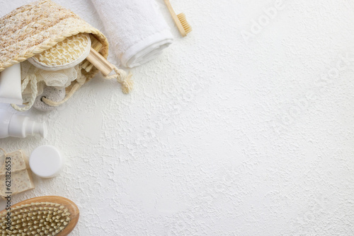Cosmetic, massage and bath accessories set on white texture background