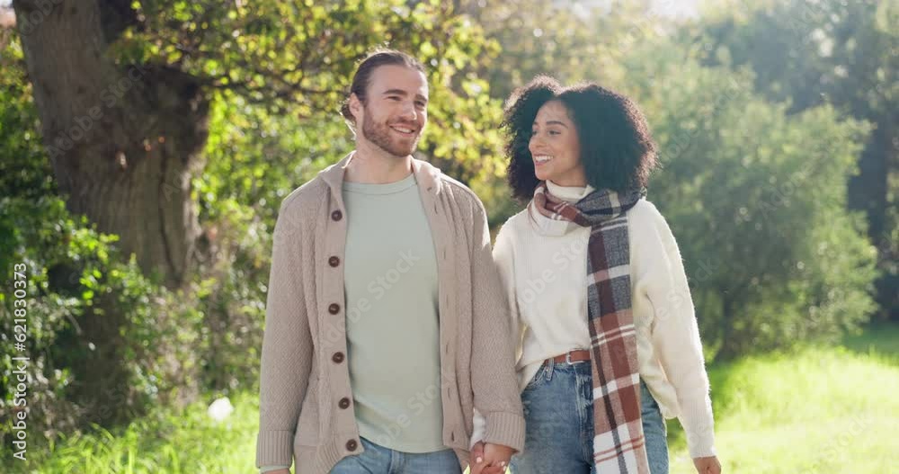 Interracial, couple and walking in park for love, care and relax on romantic date together in nature. Happy man, young woman or strolling in sunshine, spring garden or freedom of quality time outdoor