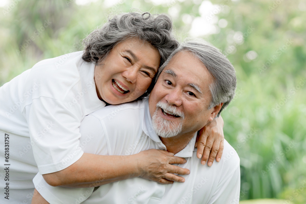 Happy love Elderly couple smile face , Senior couple old man and senior woman relaxing hug in a forest