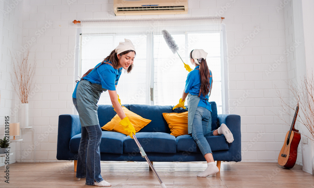 Housework or house keeping service two female cleaning dust in home, cleaning agency small business. professional equipment cleaning old home.