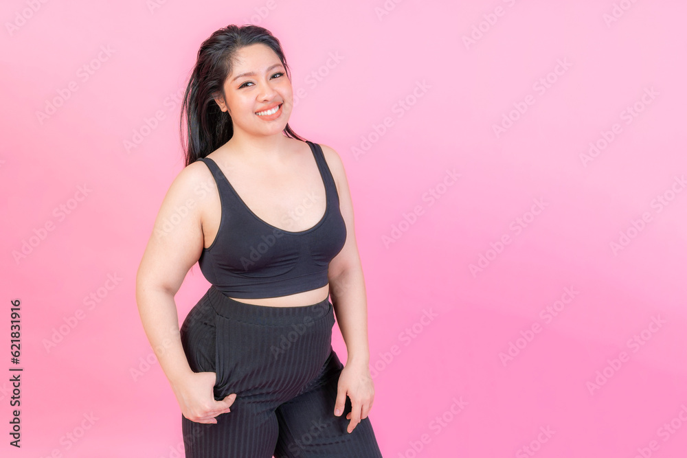 Portrait beautiful plump young woman smiling on pink background , plus size fashion model body positive concept Portrait beautiful plump young woman smiling on pink background , plus size fashion model body positive concept