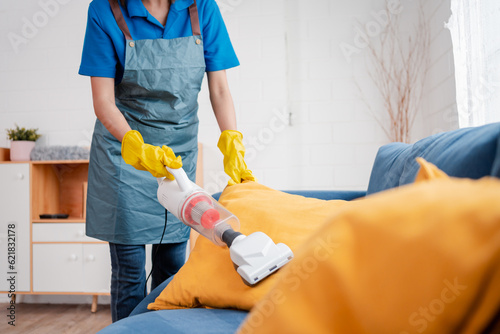 Housework or house keeping service female cleaning dust in home, cleaning agency small business. professional equipment cleaning old home.