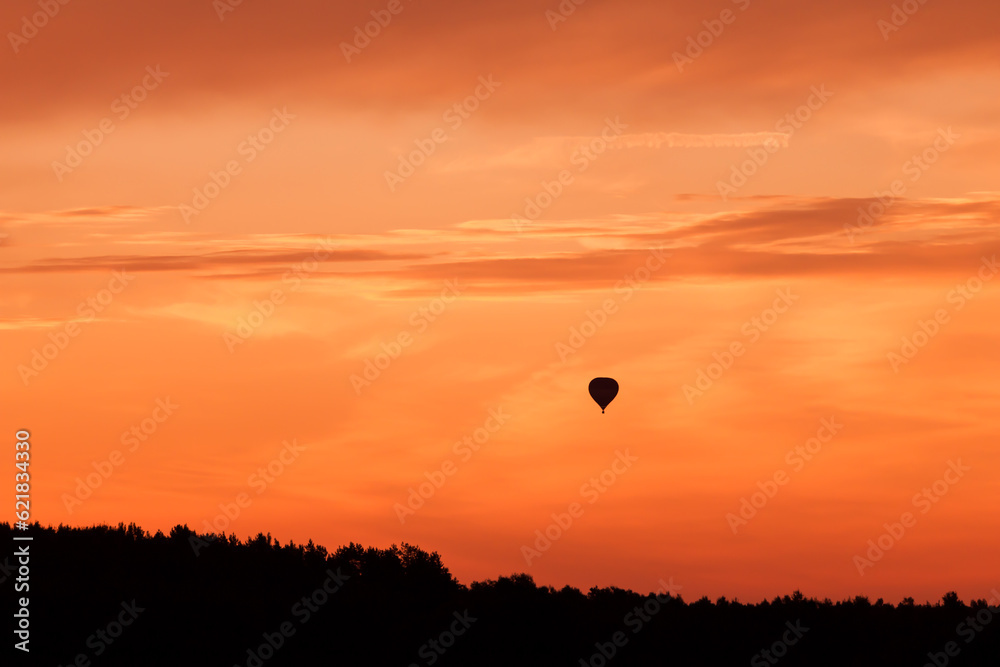 Hot air balloon flying at sunset sky Hot air balloon flying at sunset sky