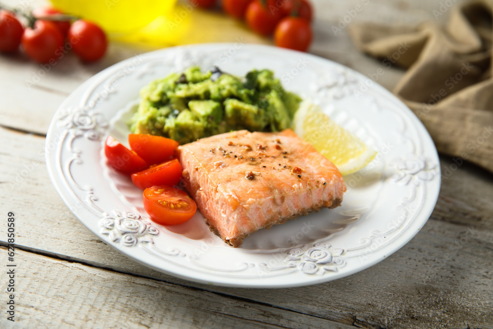 Healthy baked salmon fillet with mashed avocado