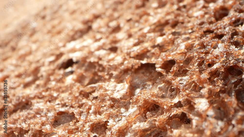 A tantalizing macro video of dark cocoa bread, captured with a probe lens. Indulge in its rich, velvety texture and deep chocolate aroma. Food concept. Bread background
