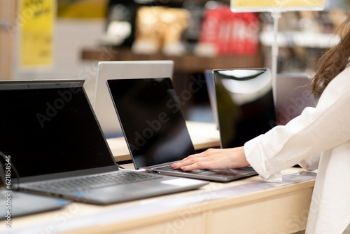 Quadro em tela client in a retail shop choosing a new laptop for studying and working