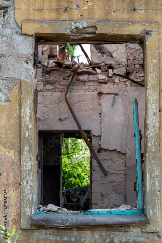 empty window of a destroyed house in Ukraine