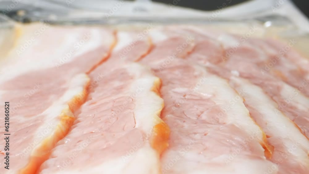 A macro video of the raw bacon. The intricate patterns and perfectly aligned fat streaks create a visually stunning display, evoking a symphony of flavors. Pork concept. Bacon background. 4K HDR
A macro video of the raw bacon. The intricate patterns and perfectly aligned fat streaks create a visually stunning display, evoking a symphony of flavors. Pork concept. Bacon background. 4K HDR