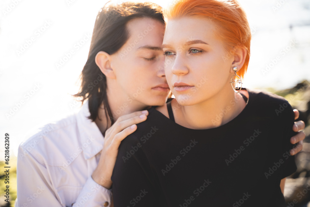 two lovers boy and girl are happy walking and hugging on the sandy beach near the sea. two lovers boy and girl are happy walking and hugging on the sandy beach near the sea.