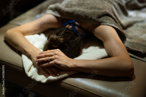 A masseuse gives a massage in a dark room